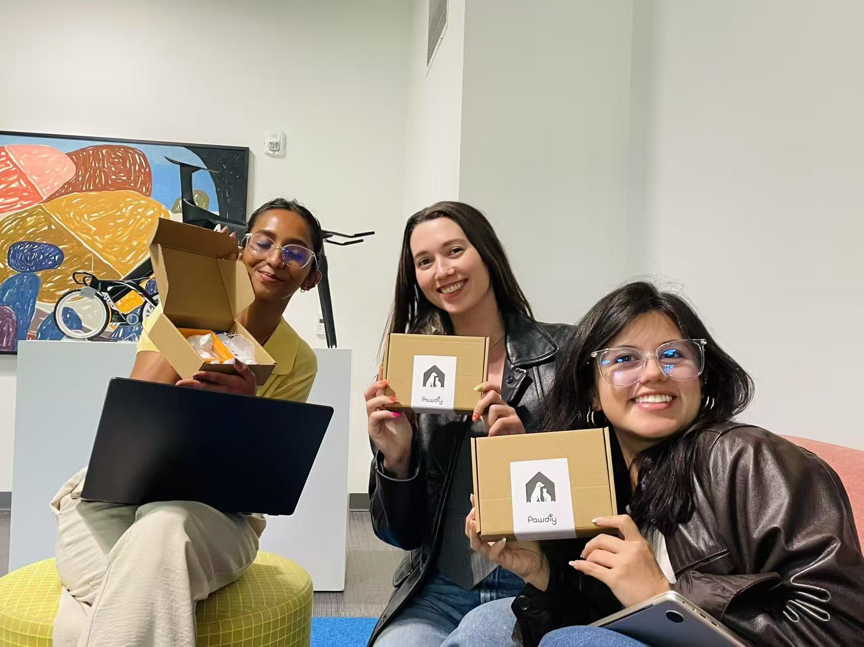 Pawdiy team holding DIY kit boxes